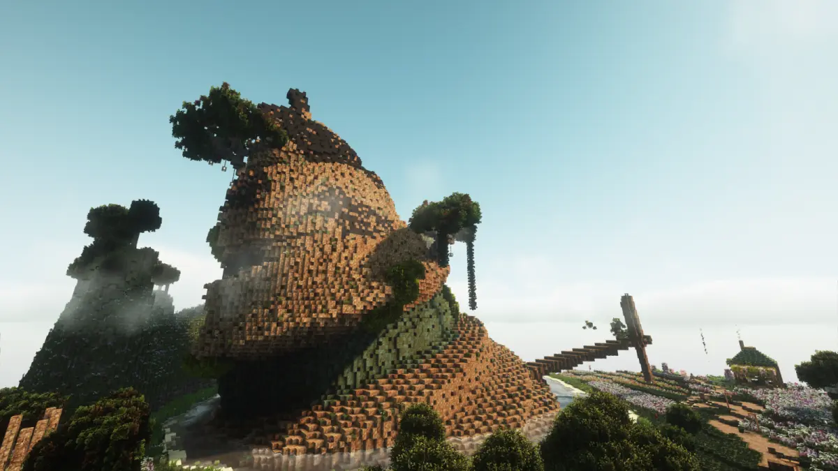 Minecraft structure surrounded by a green landscape.